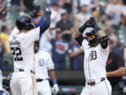 Detroit Tigers' Javier Báez, right, is greeted by Parker Meadows after a two-run home run during the eighth inning of a baseball game against the Seattle Mariners, Thursday, Aug. 15, 2024, in Detroit.