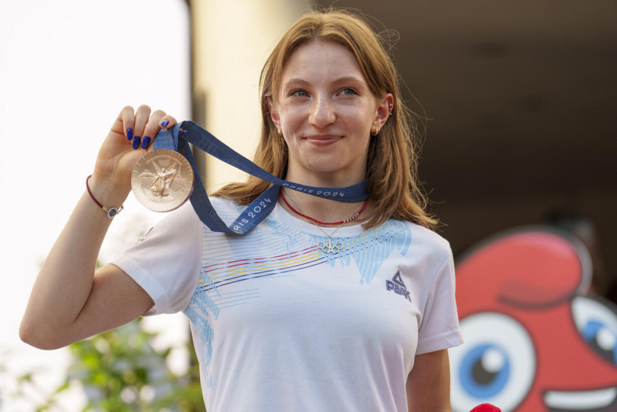 Romanian gymnast Ana Barbosu poses with the bronze medal for her women's artistic gymnastics individual floor performance at the Paris 2024 Olympics, after receiving it during a ceremony at the Romanian Olympic and Sports Committee, in Bucharest, Romania, Friday, Aug. 16, 2024. American gymnast Jordan Chiles called an arbitration panel's decision that dropped her out of the bronze medal position in the floor exercise at the Paris Olympics "unjust" and a "significant blow" in a message posted on social media Thursday.