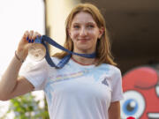 Romanian gymnast Ana Barbosu poses with the bronze medal for her women's artistic gymnastics individual floor performance at the Paris 2024 Olympics, after receiving it during a ceremony at the Romanian Olympic and Sports Committee, in Bucharest, Romania, Friday, Aug. 16, 2024. American gymnast Jordan Chiles called an arbitration panel's decision that dropped her out of the bronze medal position in the floor exercise at the Paris Olympics "unjust" and a "significant blow" in a message posted on social media Thursday.