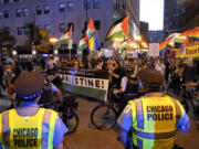 Protesters march passed a police line prior to the start of the Democratic National Convention Sunday, Aug. 18, 2024, in Chicago.