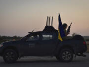 A soldier of Ukraine's 141st separate infantry brigade rides in a pickup truck at the frontline in Zaporizhzhia region, Ukraine, Monday, Aug. 19, 2024.