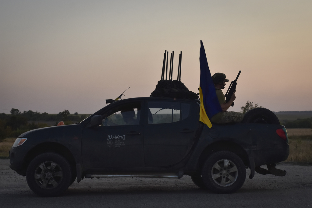 A soldier of Ukraine's 141st separate infantry brigade rides in a pickup truck at the frontline in Zaporizhzhia region, Ukraine, Monday, Aug. 19, 2024.