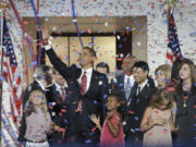 FILE - Democratic presidential candidate Sen. Barack Obama, D-Ill., waves with his family and his running mate's family after his acceptance speech at the Democratic National Convention at Invesco Field at Mile High in Denver, Aug.