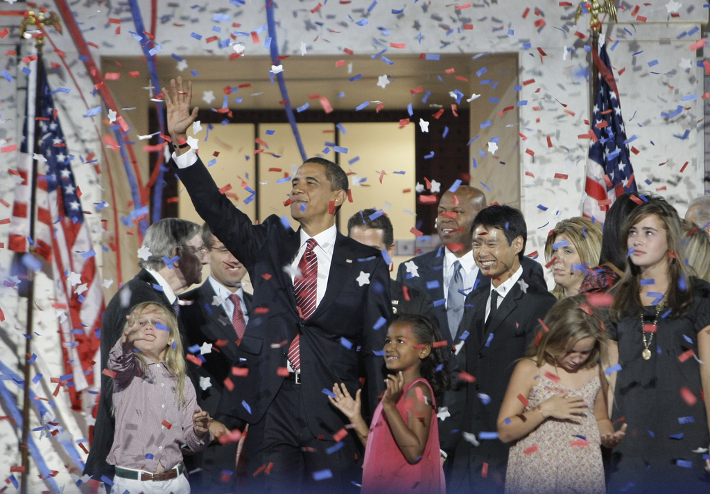 FILE - Democratic presidential candidate Sen. Barack Obama, D-Ill., waves with his family and his running mate's family after his acceptance speech at the Democratic National Convention at Invesco Field at Mile High in Denver, Aug.