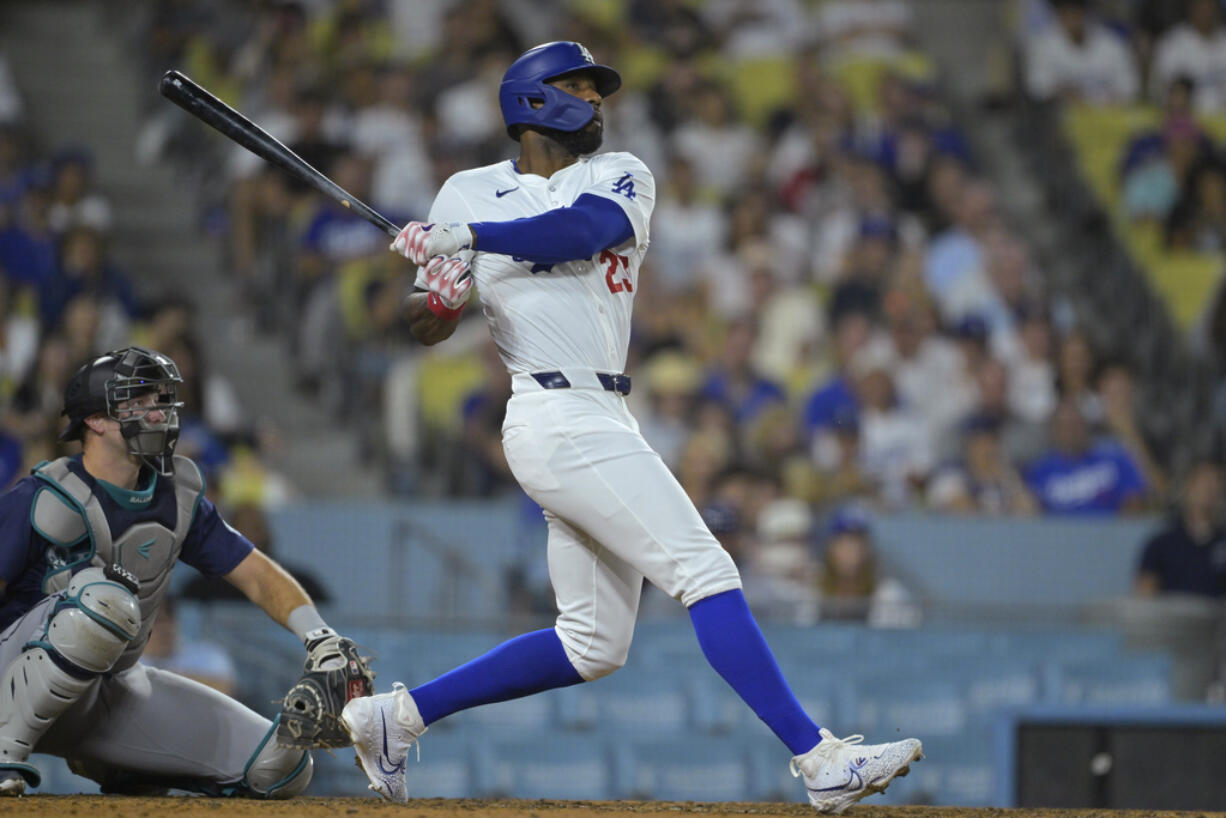 Los Angeles Dodgers Jason Heyward (23) hits a pinch hit three-run home run in the eighth inning of a baseball game against the Seattle Mariners, Tuesday, Aug. 20, 2024, in Los Angeles.