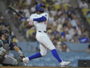 Los Angeles Dodgers Jason Heyward (23) hits a pinch hit three-run home run in the eighth inning of a baseball game against the Seattle Mariners, Tuesday, Aug. 20, 2024, in Los Angeles.