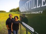 Ricky Johnson and Bridgette Murray, who work to raise awareness of issues caused by pollution, pose in front of a sign for the Pleasantville area of Houston, Saturday, Aug. 17, 2024.