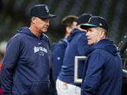 Seattle Mariners manager Dan Wilson, left, looks on next to hitting coach Edgar Martinez, right, during batting practice before a baseball game against the San Francisco Giants, Friday, Aug. 23, 2024, in Seattle.