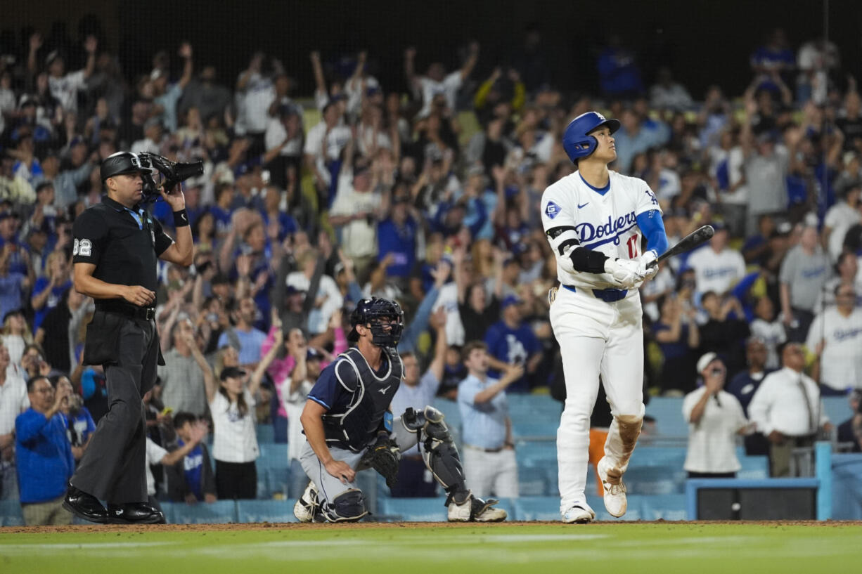 Los Angeles Dodgers designated hitter Shohei Ohtani (17) hits a grand slam during the ninth inning of a baseball game against the Tampa Bay Rays in Los Angeles, Friday, Aug. 23, 2024. The Dodgers won 7-3. Will Smith, Tommy Edman, and Max Muncy also scored.