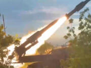 In this photo taken from video released by the Russian Defense Ministry on Sunday, Aug. 25, 2024, a Russian Army Buk-2M self-propelled, medium-range surface-to-air missile system fires at air targets in an undisclosed location in Ukraine.