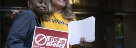 Faye Guenther, president of local UFCW 3000, hugs Carol McMillian, bakery manager at Kroger-owned King Soopers and member of Local 7, after a news conference about the Kroger and Albertsons merger outside the federal courthouse on Monday, Aug. 26, 2024, in Portland, Ore.