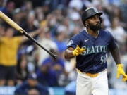 Seattle Mariners' Randy Arozarena flips his bat after hitting a three-run home run against the Tampa Bay Rays during the third inning of a baseball game Monday, Aug. 26, 2024, in Seattle.