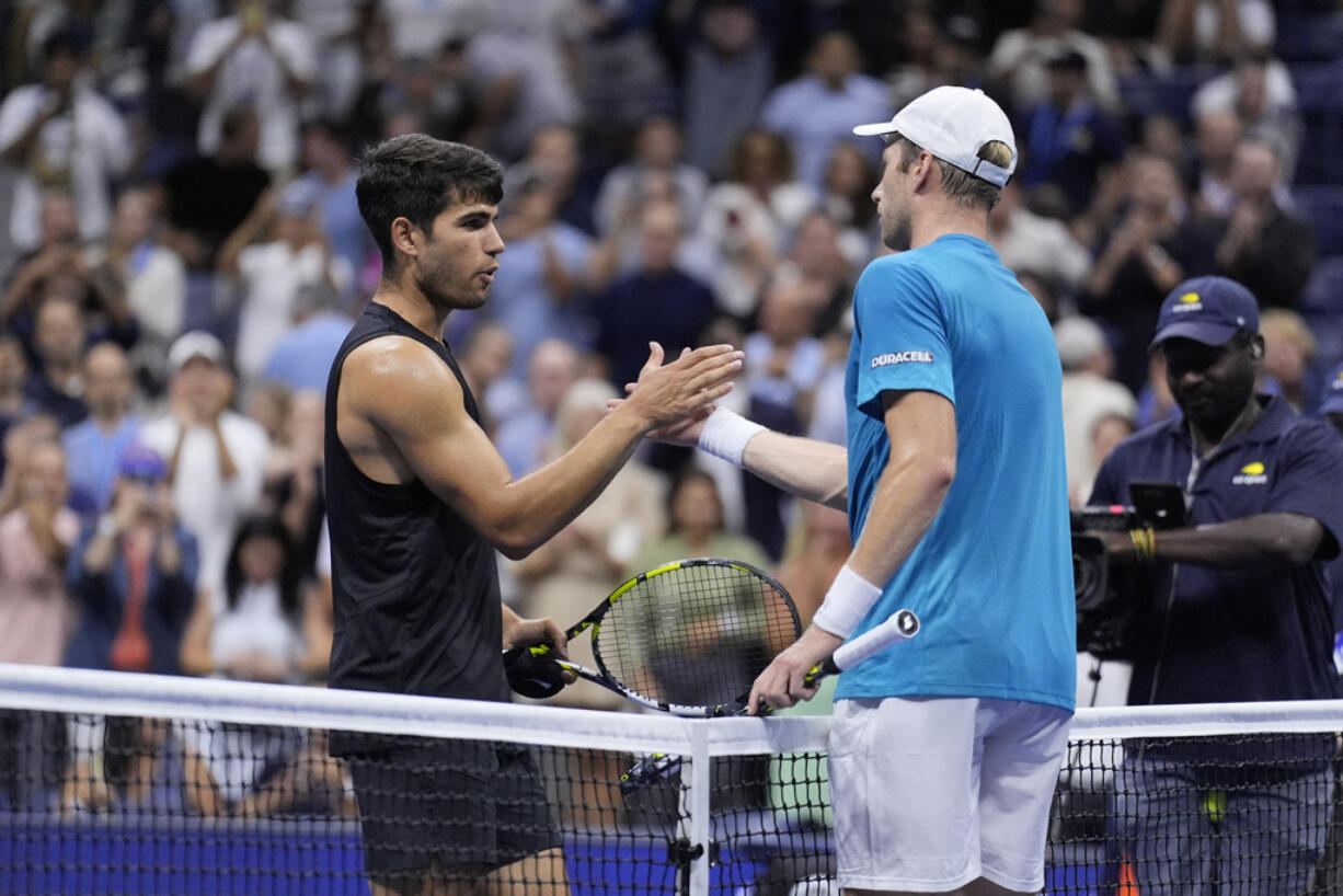 Botic van De Zandschulp, right, of the Netherlands, greets Carlos Alcaraz, of Spain, during the second round of the U.S. Open tennis championships, Thursday, Aug. 29, 2024, in New York.