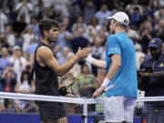 Botic van De Zandschulp, right, of the Netherlands, greets Carlos Alcaraz, of Spain, during the second round of the U.S. Open tennis championships, Thursday, Aug. 29, 2024, in New York.