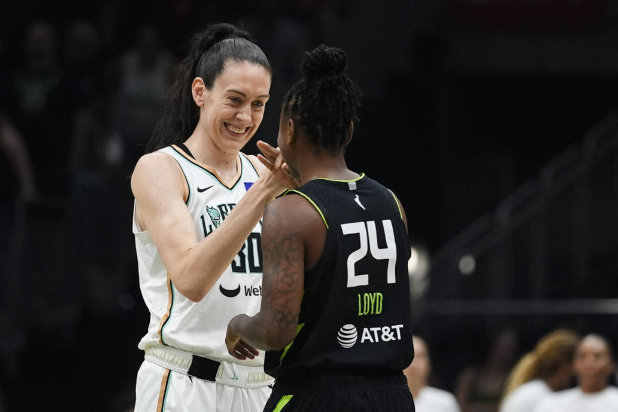 New York Liberty forward Breanna Stewart greets Seattle Storm guard Jewell Loyd before the first half of a WNBA basketball game Friday, Aug. 30, 2024, in Seattle.