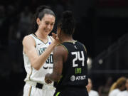 New York Liberty forward Breanna Stewart greets Seattle Storm guard Jewell Loyd before the first half of a WNBA basketball game Friday, Aug. 30, 2024, in Seattle.