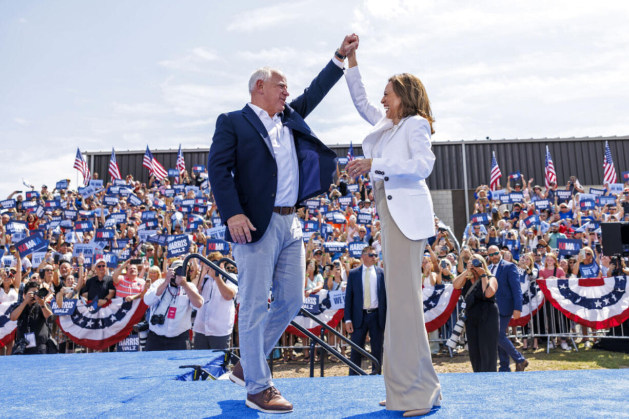 Democratic presidential nominee Vice President Kamala Harris is welcomed by running mate Democratic vice presidential nominee Minnesota Gov. Tim Walz before she delivers remarks at a campaign rally in Eau Claire, Wis., Wednesday, Aug. 7, 2024.