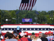 An outdoor stage is encased in bulletproof glass as supporters arrive to hear Republican presidential nominee former President Donald Trump speak Wednesday in Asheboro, N.C.