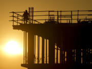 Construction workers start their day as the sun rises on the new Republic Airlines headquarters building in Carmel, Ind., Tuesday, Aug. 27, 2024.