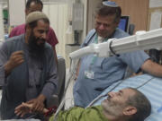 In this photo released by Soroka Medical Center on Tuesday, Aug. 27, 2024, Kaid Farhan Al-Qadi, 52, who was held hostage by Hamas militants in Gaza lies on a bed of the &rlm;Soroka Medical Center in Beersheba, Israel.