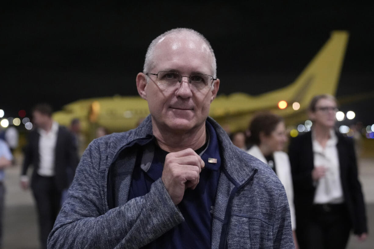 Paul Whelan shows an American flag pin he received from President Joe Biden as he arrives Friday at Kelly Field in San Antonio, Texas, after being released by Russia.