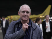 Paul Whelan shows an American flag pin he received from President Joe Biden as he arrives Friday at Kelly Field in San Antonio, Texas, after being released by Russia.