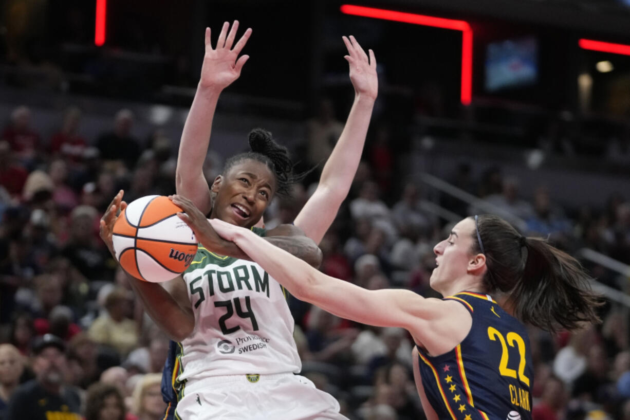 Seattle Storm&rsquo;s Jewell Loyd (24) has her shot blocked by Indiana Fever&rsquo;s Caitlin Clark (22) during the second half of a WNBA basketball game, Sunday, Aug. 18, 2024, in Indianapolis.