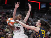 Seattle Storm&rsquo;s Jewell Loyd (24) has her shot blocked by Indiana Fever&rsquo;s Caitlin Clark (22) during the second half of a WNBA basketball game, Sunday, Aug. 18, 2024, in Indianapolis.