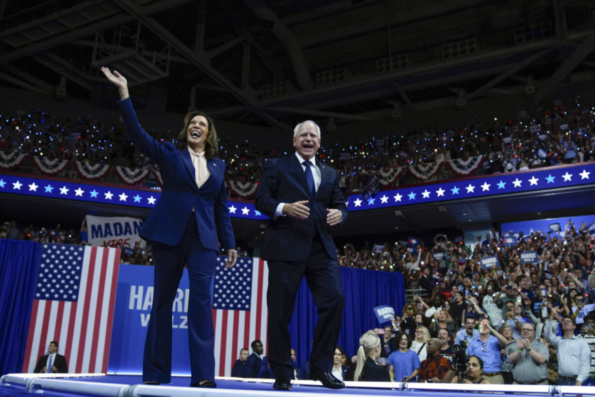 FILE - Democratic presidential nominee Vice President Kamala Harris and her running mate Minnesota Gov. Tim Walz arrive at a campaign rally in Philadelphia, Aug. 6, 2024.