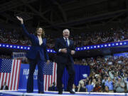 FILE - Democratic presidential nominee Vice President Kamala Harris and her running mate Minnesota Gov. Tim Walz arrive at a campaign rally in Philadelphia, Aug. 6, 2024.