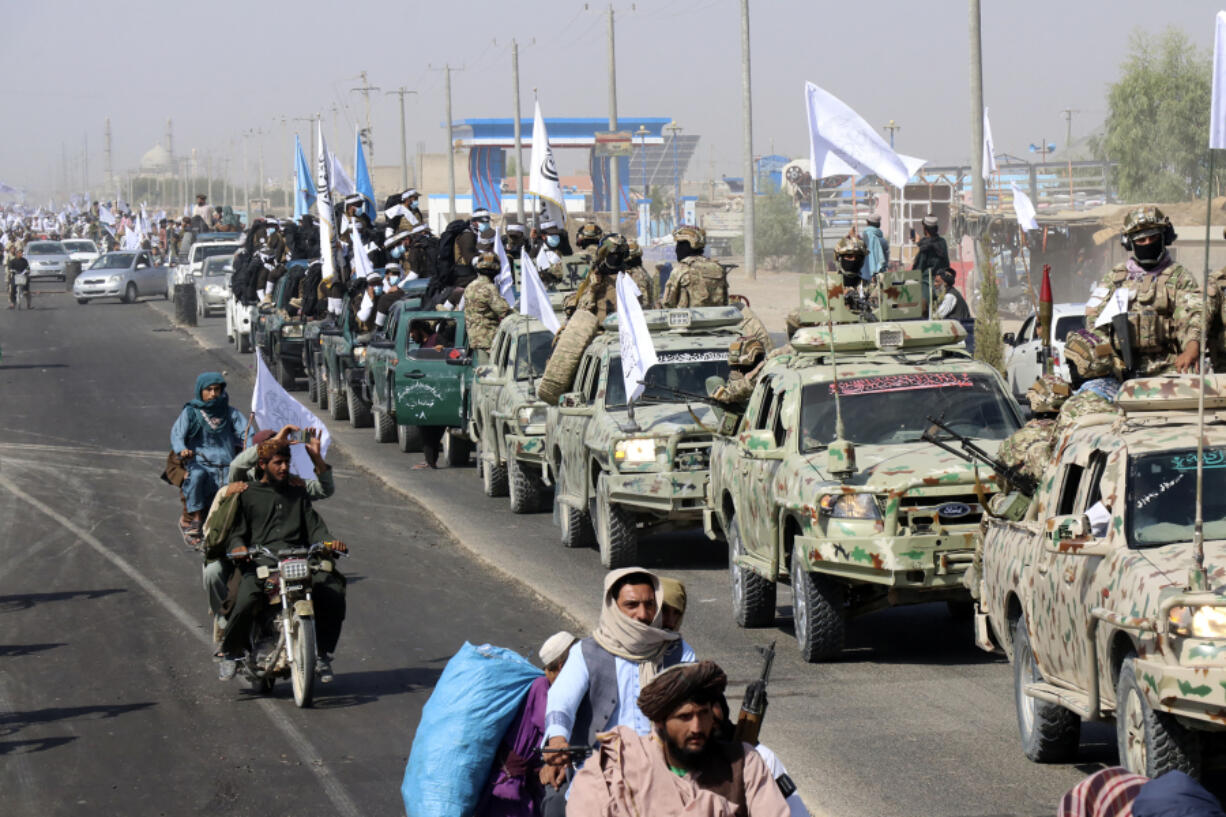 Taliban fighters celebrate the third anniversary of the withdrawal of US-led troops from Afghanistan, in Lashkar Gah, Helmand province, southwestern Afghanistan, Wednesday, Aug. 14, 2024.