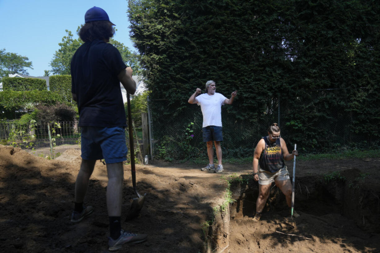 Joesph Diamond, associate professor of anthropology at New Paltz, talks to some of his students as they work at the site of an African burial ground in Kingston, N.Y., Monday, Aug. 5, 2024.