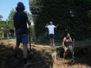 Joesph Diamond, associate professor of anthropology at New Paltz, talks to some of his students as they work at the site of an African burial ground in Kingston, N.Y., Monday, Aug. 5, 2024.