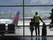 FILE - Travelers pass through Salt Lake City International Airport on May 24, 2024, in Salt Lake City. On Thursday, Aug. 1, 2024, Transportation Secretary Pete Buttigieg is expected to announce a new rule that would require airlines to do everything possible to ensure parents can sit with young children on flights.