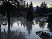 This image provided by the Alaska Department of Transportation and Public Facilities shows high water in a neighborhood in Juneau, Alaska, Monday, Aug. 6, 2024, following an outburst of flooding from a lake dammed by the Mendenhall Glacier.