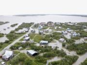 Water from an overflowing Kuskokwim River floods Napakiak, Alaska, Sunday, Aug. 18, 2024.