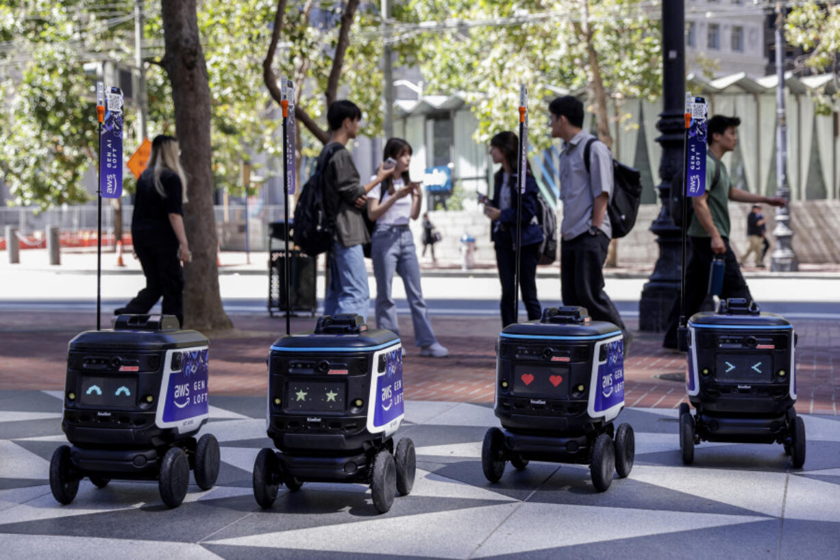 Robots line up in front of Amazon&rsquo;s AI robotics lab on Market Street in San Francisco on Tuesday, Aug. 20, 2024.