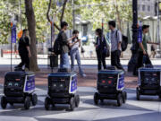 Robots line up in front of Amazon&rsquo;s AI robotics lab on Market Street in San Francisco on Tuesday, Aug. 20, 2024.