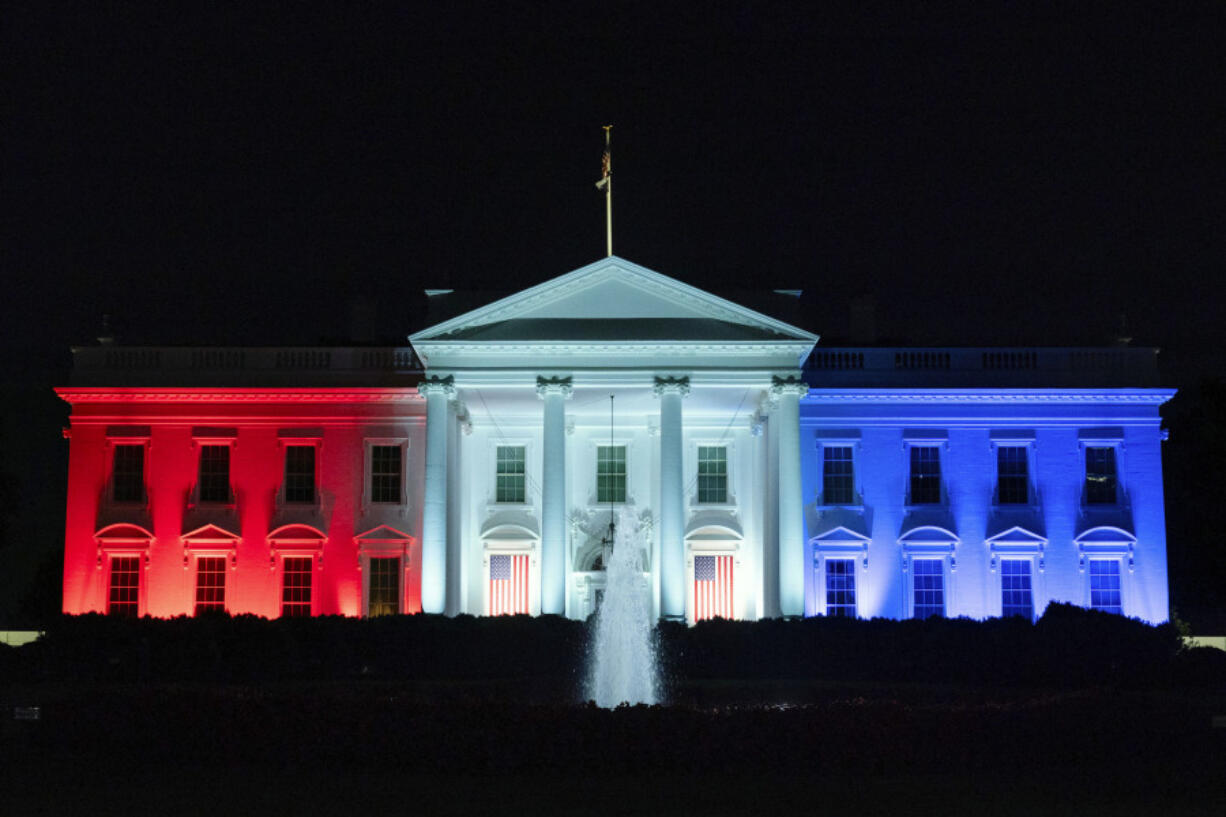 The White House is lit with the colors of the American flag to support team USA competing in the Paris Olympics, on Monday, July 29, 2024, in Washington. Former Presidents Barack Obama and George W. Bush will join an effort to commemorate America&rsquo;s 250th anniversary in 2026, highlighting the initiative&rsquo;s attempts to build bipartisan momentum in an era of extreme political polarization.  The former presidents and first ladies Michelle Obama and Laura Bush will serve as honorary national co-chairs of America250, the organization created by Congress in 2016 to oversee the celebration of the the 250th anniversary of the signing of the Declaration of Independence.