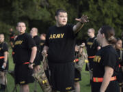 FILE - Students gather during physical training exercises in the new Army prep course at Fort Jackson in Columbia, S.C. Saturday, Aug. 27, 2022. The Army will expand its basic combat training for newly enlisted soldiers in what its leaders hope reflects a turning point as it prepares to meet the challenges of future wars. The added training will begin in October 2024 and comes as the Army works to reverse several years of dismal recruiting when it failed to meet its enlistment goals.