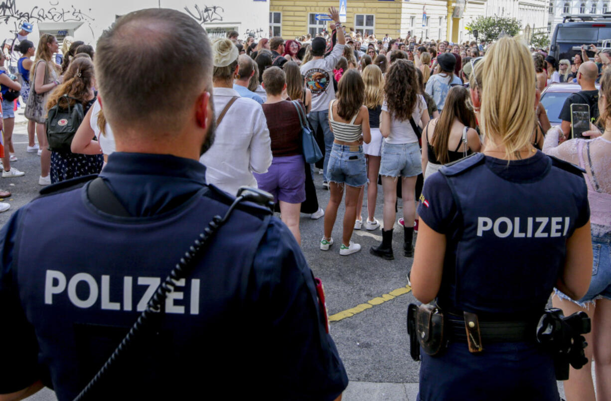 Police officers stand near gathering swifties in Vienna on Friday, Aug.9, 2024. Organizers of three Taylor Swift concerts in the stadium in Vienna this week called them off on Wednesday after officials announced arrests over an apparent plot to launch an attack on an event in the Vienna area such as the concerts.