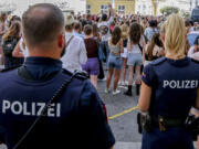 Police officers stand near gathering swifties in Vienna on Friday, Aug.9, 2024. Organizers of three Taylor Swift concerts in the stadium in Vienna this week called them off on Wednesday after officials announced arrests over an apparent plot to launch an attack on an event in the Vienna area such as the concerts.