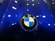 FILE - The company logo shines on the hood of an unsold vehicle at a Mini Honda BMW dealership on July 22, 2024, in Highlands Ranch, Colo.