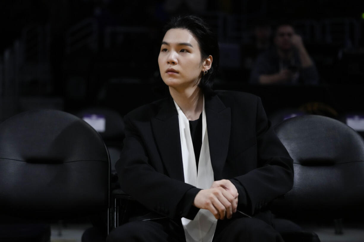 FILE - BTS member Suga attends an NBA basketball game between the Los Angeles Lakers and the Dallas Mavericks on Jan. 12, 2023, in Los Angeles. (AP Photo/Jae C.