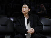 FILE - BTS member Suga attends an NBA basketball game between the Los Angeles Lakers and the Dallas Mavericks on Jan. 12, 2023, in Los Angeles. (AP Photo/Jae C.