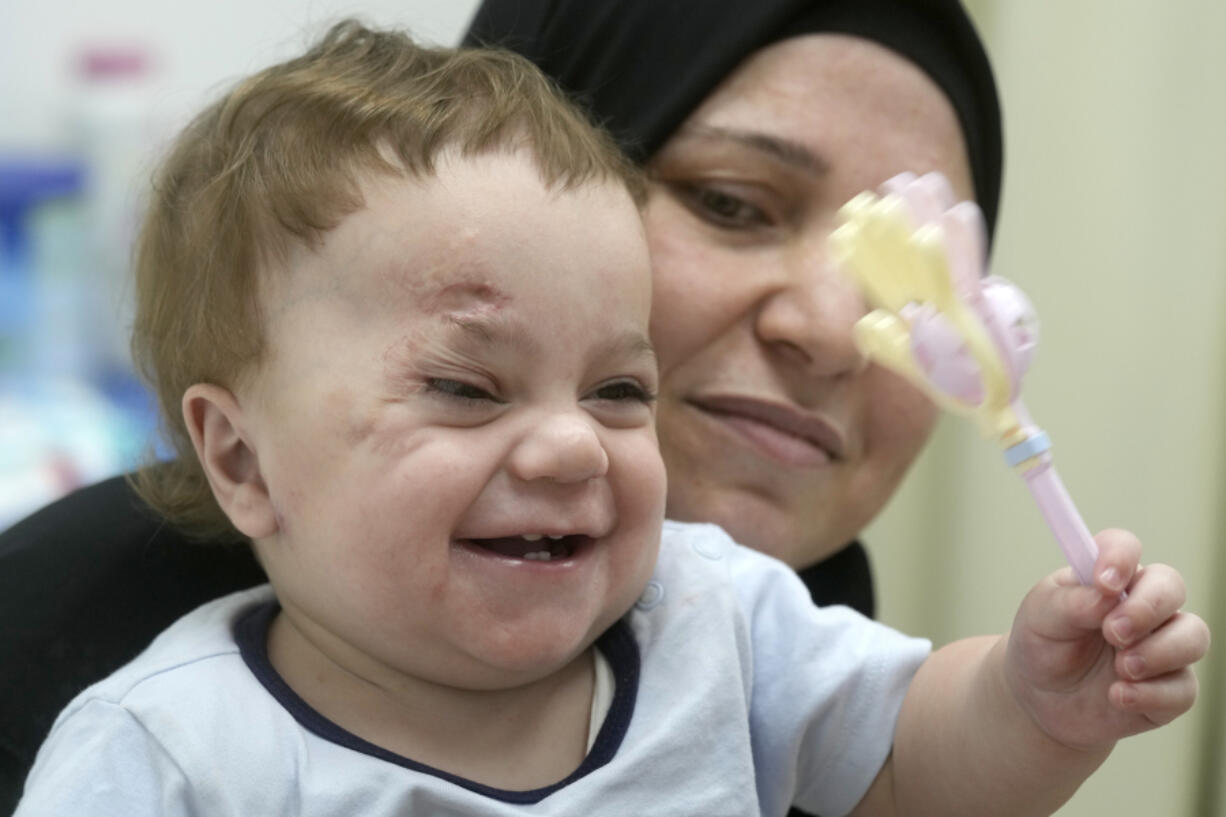 In this Aug. 14, 2024 photo, ten-month-old Palestinian infant Mostafa Qadoura, who has already lost his eye and his immediate family to the horrors of Israel&rsquo;s war against Hamas in Gaza, plays with his grandmother Amna Abd Rabou, at the New Administrative Capital Hospital, just outside Cairo, Egypt. Mostafa was among the 28 babies, most of whom were born premature, who were evacuated from the then-besieged Shifa Hospital in Gaza City and transported to Egypt late last year.