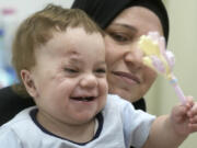 In this Aug. 14, 2024 photo, ten-month-old Palestinian infant Mostafa Qadoura, who has already lost his eye and his immediate family to the horrors of Israel&rsquo;s war against Hamas in Gaza, plays with his grandmother Amna Abd Rabou, at the New Administrative Capital Hospital, just outside Cairo, Egypt. Mostafa was among the 28 babies, most of whom were born premature, who were evacuated from the then-besieged Shifa Hospital in Gaza City and transported to Egypt late last year.