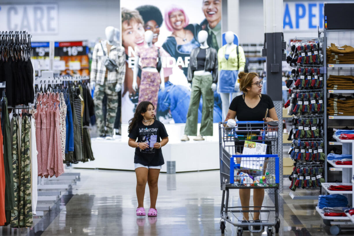 Shoppers pass clothing from Walmart&rsquo;s No Boundaries brand at a Walmart Superstore in Secaucus, New Jersey, Thursday, July 11, 2024. Walmart relaunched No Boundaries, its 30-year-old brand for teenagers and young adults, earlier this month with a new 130-piece fall collection.