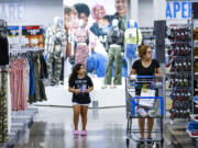 Shoppers pass clothing from Walmart&rsquo;s No Boundaries brand at a Walmart Superstore in Secaucus, New Jersey, Thursday, July 11, 2024. Walmart relaunched No Boundaries, its 30-year-old brand for teenagers and young adults, earlier this month with a new 130-piece fall collection.