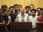 Nobel laureate Muhammad Yunus speaks to the media after his arrival at the airport in Dhaka, Bangladesh, Thursday, Aug. 8, 2024.